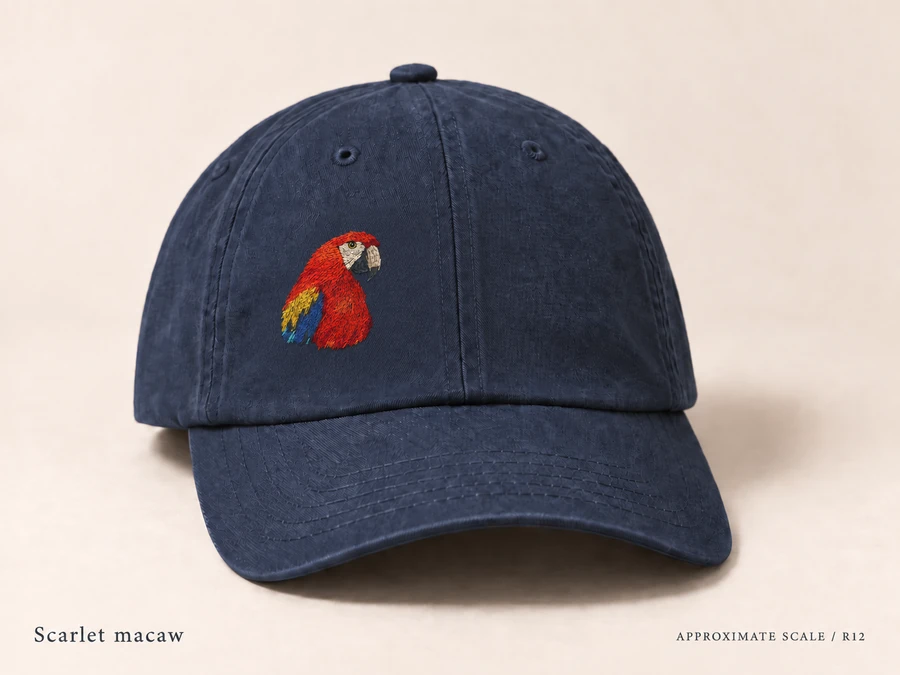 Earlier illustrative Scarlet macaw cap study; superseded design